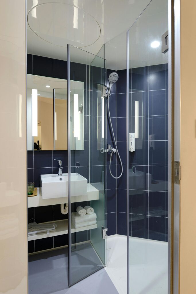 pexels photo 271631 271631 Sleek modern bathroom with a glass shower and contemporary design elements.