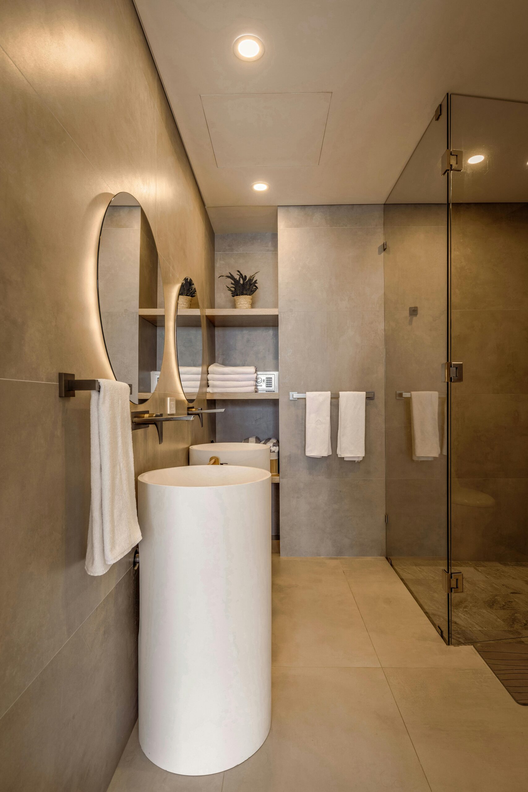 pexels photo 29559663 29559663 Elegant minimalist bathroom featuring a round lit mirror and sleek fixtures in neutral tones.