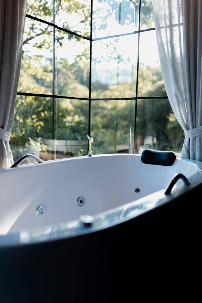 pexels photo 29887327 29887327 Elegant bathtub by large window with a breathtaking nature view, perfect for relaxation.