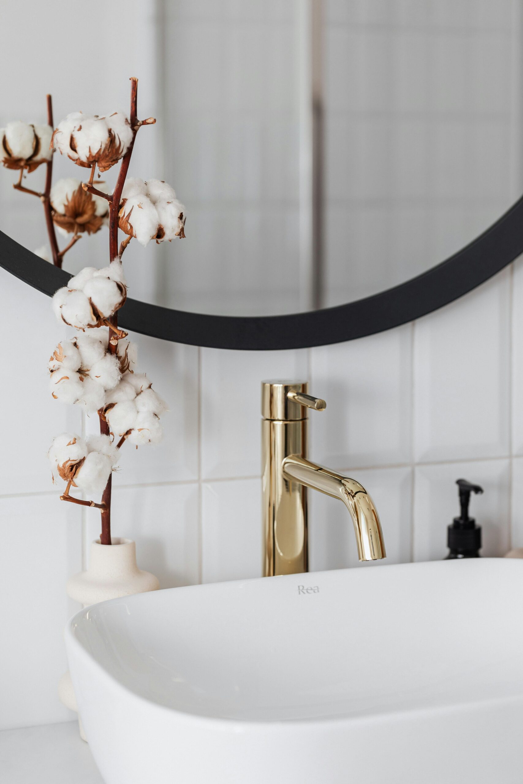 pexels photo 4194987 4194987 Stylish bathroom featuring a sleek golden faucet and cotton plant decoration.