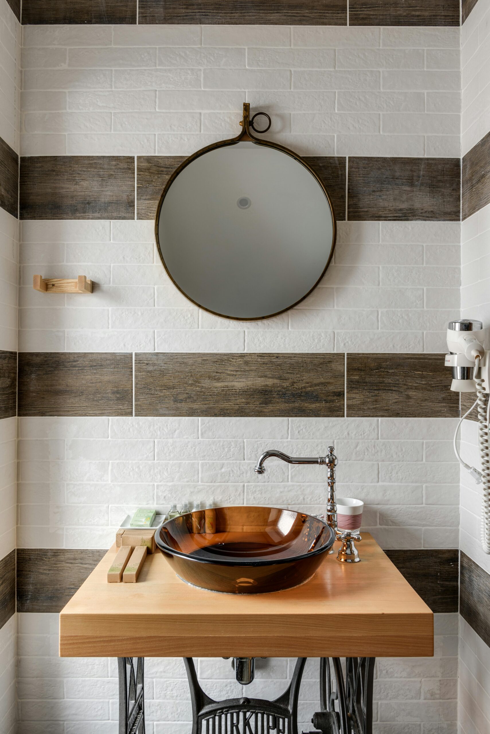 pexels photo 7745938 7745938 Stylish bathroom interior featuring a modern vessel sink, round mirror, and unique design elements.